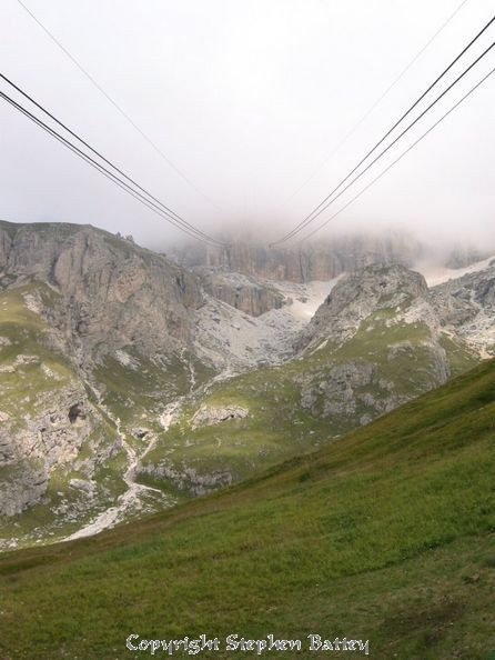 The cable-car cables hang down from the clouds