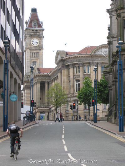 A cyclist struggles up Hill Street