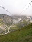 The cable-car cables hang down from the clouds