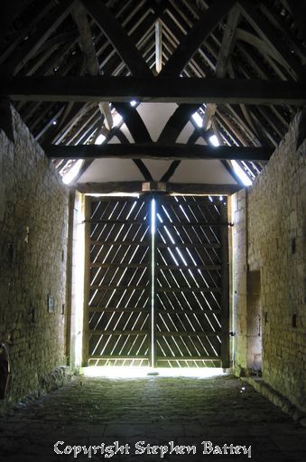 Daylight shines between the beams of the barn doors