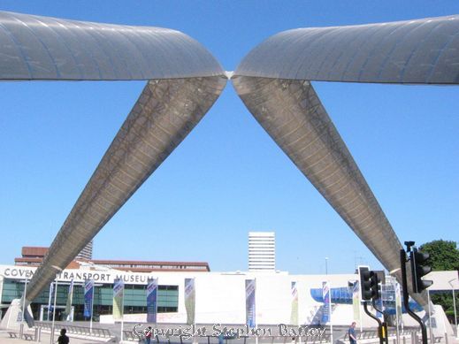 The steel arches sweep across the blue expanse