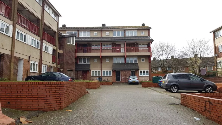 Block of maisonettes with a car park at the front